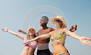 Group of friends smiling at the beach