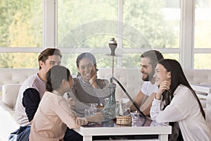 Group of friends smoking shisha, hanging out together photo