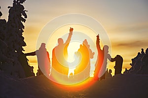 Group of friends snowboarders having fun on the top of mountain