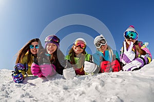 Group of friends snowboarders having fun on the top of mountain