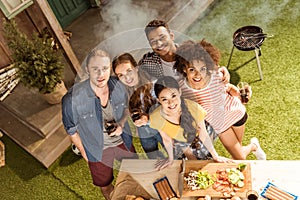 Group of friends spending time together at barbecue