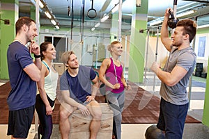 Group of friends with sports equipment in gym