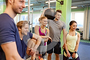 Group of friends with sports equipment in gym