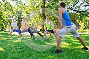 Group of friends or sportsmen exercising outdoors