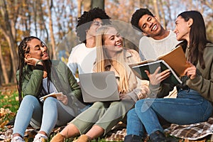 Group of friends students studying at autumn park