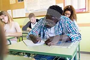 Group of friends studying in a university classroom.