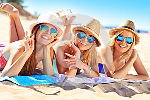 Group of friends sunbathing on the beach