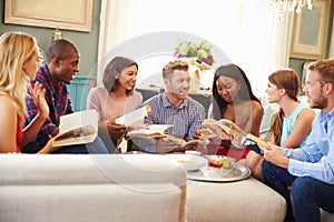 Group Of Friends Taking Part In Book Club At Home