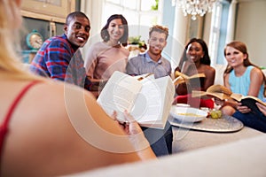 Group Of Friends Taking Part In Book Club At Home