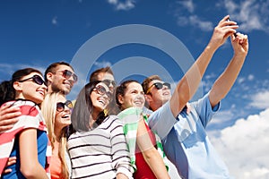 Group of friends taking picture with smartphone