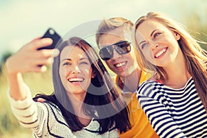 Group of friends taking picture with smartphone