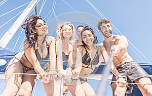 Group of friends taking selfie from the boat