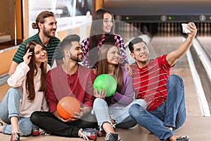 Group of friends taking selfie in bowling