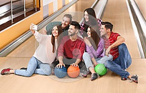 Group of friends taking selfie in bowling