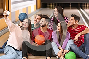 Group of friends taking selfie in bowling