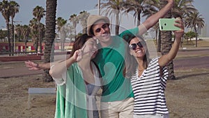 Group of friends taking selfie happy laughing in the beach in summer.