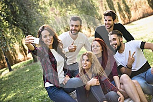 Group of friends taking selfie in urban background