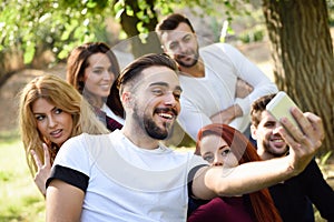 Group of friends taking selfie in urban background