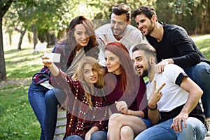 Group of friends taking selfie in urban background