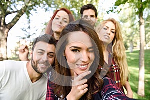 Group of friends taking selfie in urban background