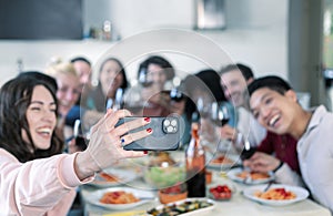 Group Of Friends Taking Selfies During Lunch indoors