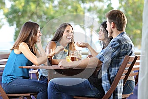 Group of friends talking and drinking at home photo