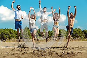 Group of friends together on the beach having fun.