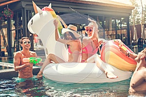 Group of friends together in the swimming pool leisure