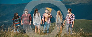 Group of friends tourists, spring banner. Young people hiking in countryside. Hiking group. Adventure travel hike and