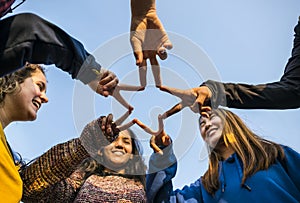 Group of friends using fingers to form the star shape teamwork and support concept