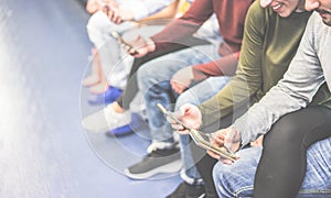 Group of friends using mobile phones in metro subway - Concept of people addiction to technology trends - Alienation moment for photo