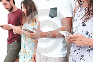 Group of friends using smartphone outdoors - Young people spend time together with internet - technology and social network