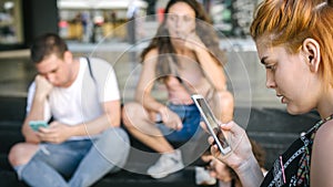 Group of friends using smartphones. Emotional isolation and technology depresion