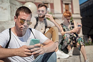 Group of friends using smartphones. Emotional isolation and technology depresion photo