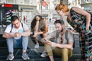 Group of friends using smartphones. Emotional isolation and technology depresion photo