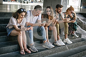 Group of friends using smartphones. Emotional isolation and technology depresion photo