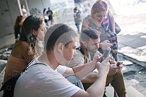 Group of friends using smartphones. Emotional isolation and technology depresion photo