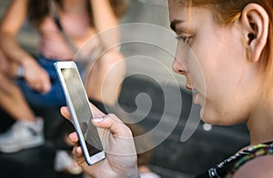 Group of friends using smartphones. Emotional isolation and technology depresion photo