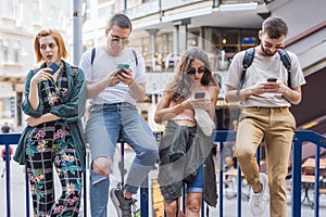 Group of friends using smartphones. Emotional isolation and technology depresion photo