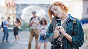 Group of friends using smartphones. Emotional isolation and technology depresion photo