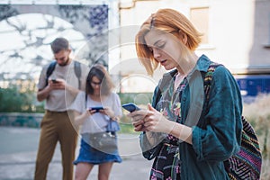 Group of friends using smartphones. Emotional isolation and technology depresion photo