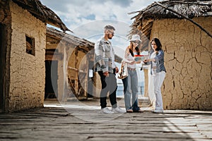 Group of friends on vacation exploring ancient village with a map