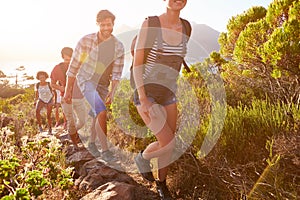 Group Of Friends Walking Along Coastal Path Together