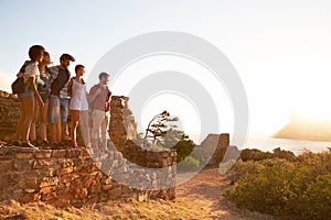 Group Of Friends Walking Along Coastal Path Together