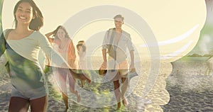 Group of friends walking on beach, enjoying sunshine