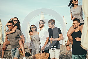 Group of Friends Walking at Beach, having fun, womans piggyback on mans, funny vacation