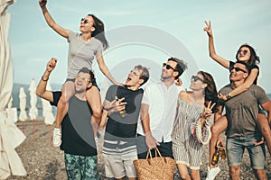 Group of Friends Walking at Beach, having fun, womans piggyback on mans, funny vacation