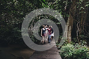 Group of friends walking through a forest