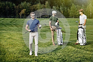 Group of friends walking on the golf course