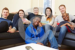 Group Of Friends Watching Television At Home Together